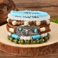 Bracciale multistrato boho con perline turchesi e ciondolo vintage a testa di toro - Multicolore