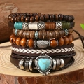 Stack of vintage leather bracelets with wood beads and turquoise heart charm on wood - Heart Turquoise Hand Braided Style (03)