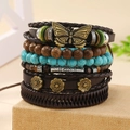 Detail view of boho stacked bracelets with leather cord, wood beads and turquoise charms - Metal Butterfly Flower Style (06)