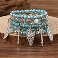 Detail of bohemian turquoise and wood bead bracelets with silver feather and arrow charms - Style 06