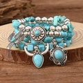 Detailed close-up of Bohemian turquoise beaded bracelets with vintage silver charms - Style 07