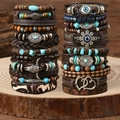 Close-up of bohemian leather beaded bracelets with bull head charms on wood base - Set: Style 4