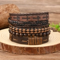 Detail of bohemian multilayer leather bracelets with wood beads on a wooden stand - Cross Stitch Woven Style (Style 6)