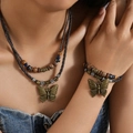 Detailed view of layered woven leather necklace with bronze butterfly pendant and beads - Butterfly Pendant Necklace And Bracelet Set