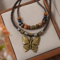 Vintage multilayer woven necklace with bronze butterfly pendant and ethnic style wood beads - Butterfly Pendant Necklace