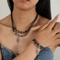 Detail of bohemian layered necklace and bracelet with wood beads and leaf charms - Leaf Pendant Necklace And Bracelet Set