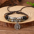 Close-up of handmade ethnic beaded bracelet with a Tree of Life charm on wood background - Bracelet 16