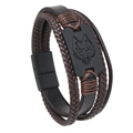 Detalle de pulsera de cuero trenzado multicapa con dije de cabeza de lobo en metal mate - Marrón