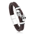 Punk brown braided leather bracelet featuring silver metal skull charms and magnetic clasp - Brown