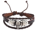 Macro detail of multi-layer leather bracelet with vintage silver skull and braided ropes - Skull Style / Brown
