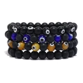 Set mit vier mattschwarzen Vulkanstein-Perlenarmbändern mit bunten Evil Eye Anhängern - Mehrfarbig
