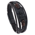 Macro shot of men's leather bracelet showing eagle relief on black alloy plate - Brown
