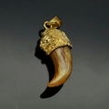 Detailed close-up of a golden lion head pendant with a curved resin faux tusk element - Gold Amber Tiger Tooth (No Chain)