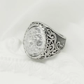 Macro detail of vintage silver ring featuring a white cracked stone and ornate carvings - Steel Band + White Stone