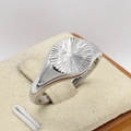 Minimalist silver signet ring with engraved sunburst pattern on circular surface - US 6 / Steel
