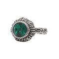 Macro shot of retro steel ring featuring faceted green gemstone and textured silver band - Green