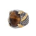 Macro view of gold dragon claws holding a tiger eye stone on a vintage steel ring - US 7 / Gold Tiger's Eye
