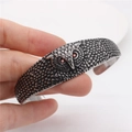 Vintage owl cuff bracelet with red rhinestone eyes and antique silver feather carvings - Owl Style