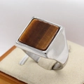 Men's titanium steel ring with square brown tiger eye stone on a jewelry display stand - US 7 / Tiger's Eye