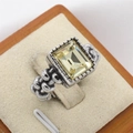 Vintage silver ring featuring a large rectangular pale yellow gemstone on beige velvet - Steel Color Yellow Rhinestone