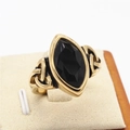 Vintage golden Celtic ring with large marquise-cut black stone and intricate triquetra detail - Gold Black Stone