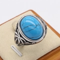 Bague rétro en acier avec pierre turquoise ovale et gravures de palmiers tropicaux - US 7 / Pierre Bleue