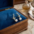 Elegant gold S-shape spiral pearl drop earrings with cubic zirconia in a blue box - E1255-6