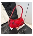 Detail der roten Tasche mit Krokodilprägung und silbernen Schnallen auf Leder - Rot