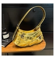 Detailed view of crocodile embossed pattern and metallic buckle straps on gold underarm bag - Gold