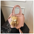 Pink textured faux leather crossbody bag with teddy bear charm and top handle strap - Pink with Pendant
