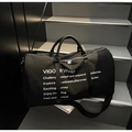 Large black canvas travel tote bag with leather handles and white text on steps - Black