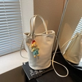 Chic white bucket bag with cartoon charm, pearl chain and long crossbody strap - White