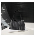 Detail of black pebbled leather handbag with decorative silver metal grommets - Small Eyelet / Black