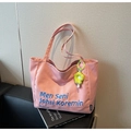 Detailed shot of pink canvas tote bag with blue embroidery and sunflower charm - Pink with Pendant