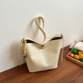 Cream-colored bucket bag in lychee leather with gold clasp and heart charm detail - Yellow