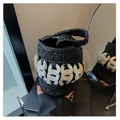 Detail of hand-woven black straw bucket bag with white acrylic ring chain accents - Black