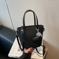Black pebbled leather bucket bag with silver heart charm and detachable shoulder strap - Black