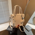 White pebbled leather bucket bag with top handles and adjustable shoulder strap - Off-white