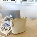 Chic cream litchi texture bucket bag with silver charm and thin leather strap - White with Pendant