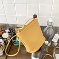 Chic yellow lychee leather bucket bag with shoulder strap and minimalist PANTOA logo - Yellow with Pendant