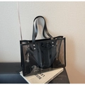 Close-up of transparent PVC tote bag with black trim and silver rivets details - One Size / Brown