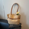 Handwoven straw tote bag with brown leather handles and decorative belt detail - Brown