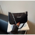 Close-up of black nylon shoulder bag with silver chain detail and white logo print - Black