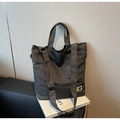 Close-up of a vintage dark grey canvas tote bag with functional pockets and long straps - Black