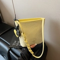 Light yellow crocodile pattern bucket bag with woven shoulder strap and heart charm - Yellow