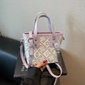 Lavender embroidered bucket bag with geometric floral patterns and purple leather handles - Purple
