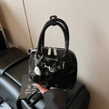 Glossy black Boston handbag with silver hardware and a heart-shaped mirror charm - Black