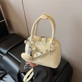 Beige shell-shaped handbag in glossy finish with heart charm and shoulder strap - Yellow