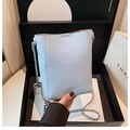 Detailed view of light blue lychee pattern leather handbag in elegant gift box - Cloud Blue