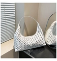 White hobo bag with silver studs and smooth leather finish shown in a stylish setting - White